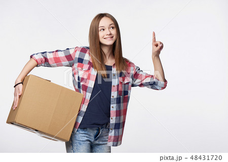Smiling young delivering cardboard box looking at camera 48431720