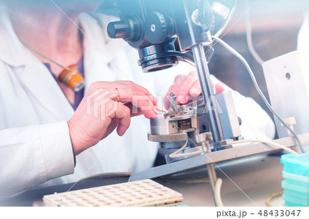 Elderly female hand with industrial microscope 48433047
