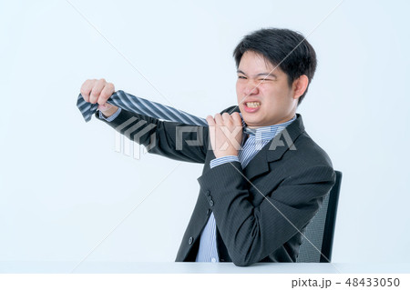 asian businessman try to solve business problem asian businessman try to solve business problem 48433050