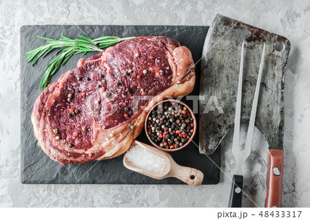 Marbling ribeye steak on black plate Marbling ribeye steak on black plate 48433317