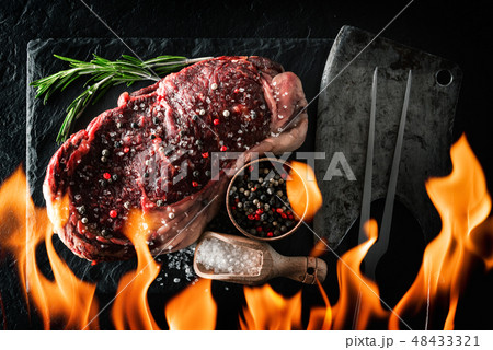 Marbling ribeye steak on black plate Marbling ribeye steak on black plate 48433321