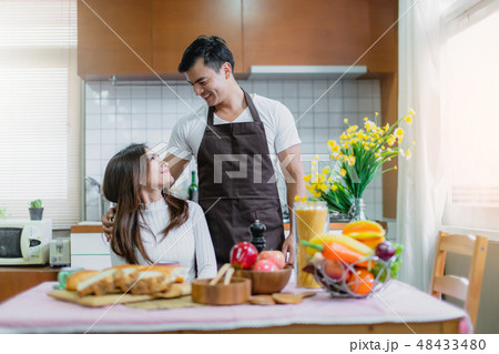 sweet asian couple happiness preparing breakfast 48433480