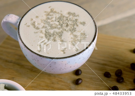 Cup of coffee with halva served on a tray with honey and coffee beans. Cup of coffee with halva served on a tray with honey and coffee beans. 48433953