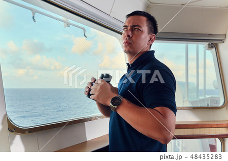 Portrait of navigator pilot officer on the bridge of the vessel 48435283