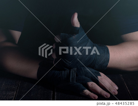 Hands of fighter in modern style on black background. Health care concept. 48435285