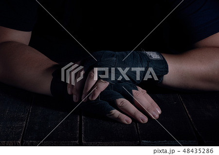 Hands of fighter in modern style on black background. Health care concept. 48435286