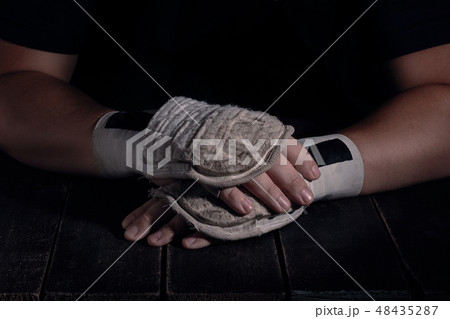 Hands of fighter in modern style on black background. Health care concept. 48435287