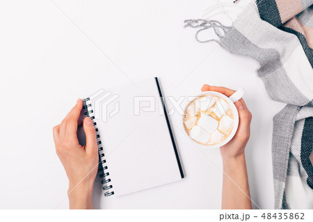Woman's hands holding cup of coffee Woman's hands holding cup of coffee 48435862