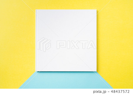white square notebook on yellow and blue paper white square notebook on yellow and blue paper 48437572