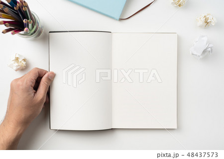 man hand hold brown notebook on white background man hand hold brown notebook on white background 48437573