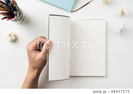 man hand hold brown notebook on white background man hand hold brown notebook on white background 48437575