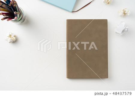 man hand hold brown notebook on white background man hand hold brown notebook on white background 48437579
