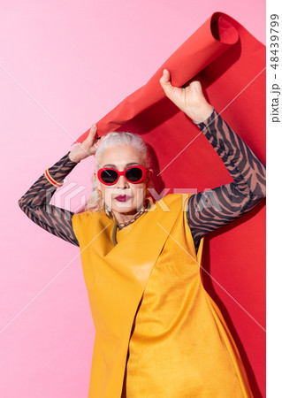 Pretty elderly blonde model raising both hands 48439799