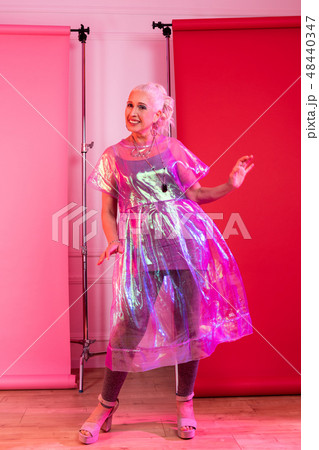 Positive delighted mature female dancing during shooting 48440347