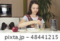 Teen girl with dog Papillon prepare cookies, knead the dough 48441215