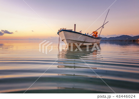 Blue sea at sunset, boat fishing  Shore landscape bay. Summer  scenery. Blue water.   48446024