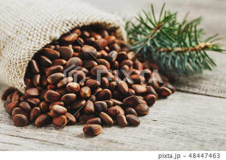 Pine nuts in a bag of burlap on an old vintage 48447463