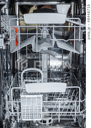 open dishwasher is ready to load dirty dishes. open dishwasher is ready to load dirty dishes. 48448719