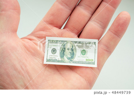 hand holding small banknote of US dollar 48449739
