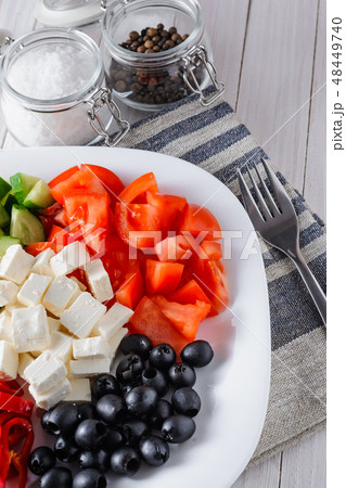 salad of tomatoe, olives, cucumber and feta cheese 48449740