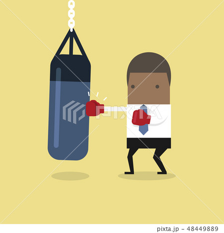 African businessman punching the punch bag. African businessman punching the punch bag. 48449889
