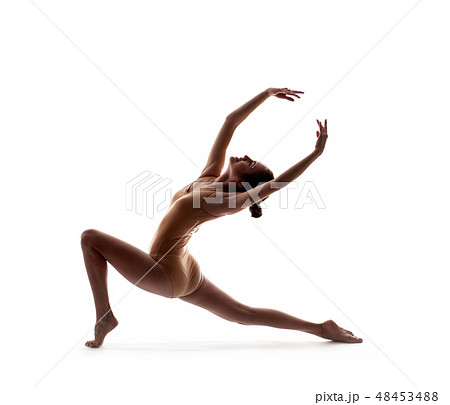 young beautiful dancer in beige swimsuit posing young beautiful dancer in beige swimsuit posing 48453488