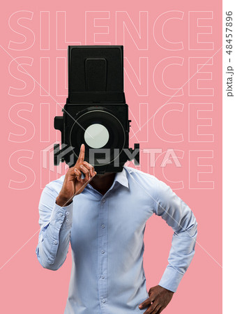 Studio portrait of young man covering his mouth - speak no evil concept 48457896
