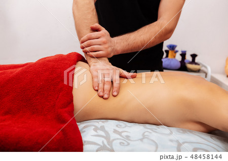 Experienced worker in black t-shirt putting whole palm on waist of client Experienced worker in black t-shirt putting whole palm on waist of client 48458144