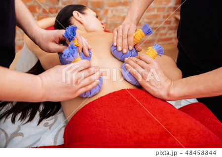 Partly-naked woman getting calming treatment in salon Partly-naked woman getting calming treatment in salon 48458844
