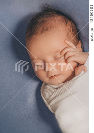 portrait of a newborn baby with a pen at the face portrait of a newborn baby with a pen at the face 48460181