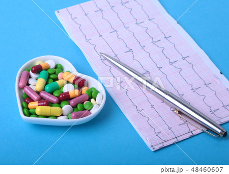 RX prescription and colorful assortment pills and capsules on plate. RX prescription and colorful assortment pills and capsules on plate. 48460607