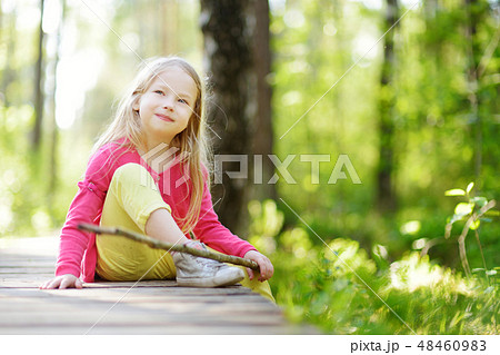 Cute little girl having fun during forest hike on beautiful summer day Cute little girl having fun during forest hike on beautiful summer day 48460983