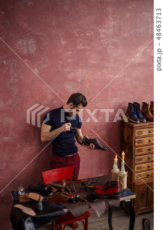 young cobber checking the insole of stylish footwear 48463713