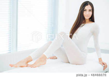 Young Brunette Woman In White Slimming Bodysuit Waiting For Lpg