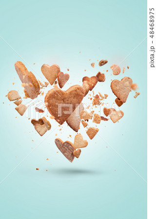 Card with flying crisp biscuit in shape of heart 48468975