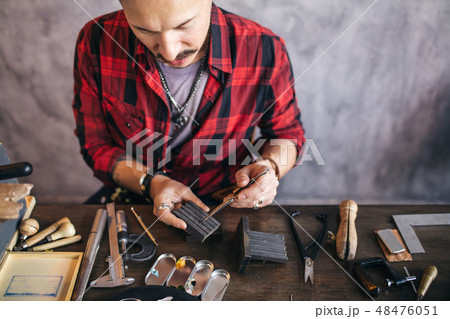 hardworking goldsmith spending time in the workshop 48476051