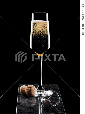 Elegant glass of yellow champagne with cork 48477134