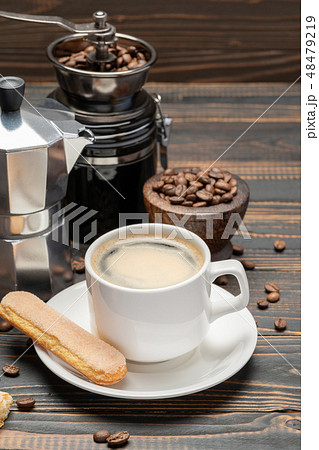 Cup of coffee with coffe maker on wooden backround Cup of coffee with coffe maker on wooden backround 48479219