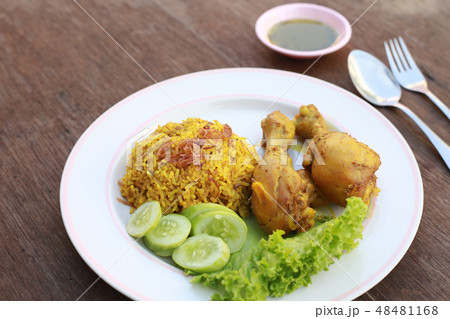 Muslim yellow rice with chicken in a white plate  48481168