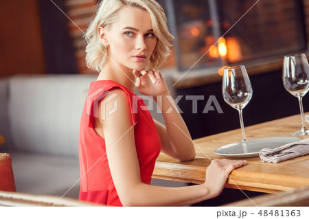 Young woman on date in restaurant sitting looking out the window sensual Young woman on date in restaurant sitting looking out the window sensual 48481363