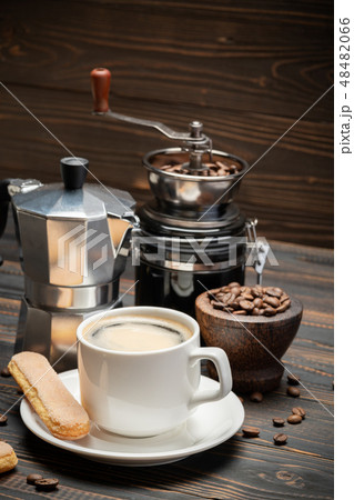 Cup of coffee with coffe maker on wooden backround 48482066