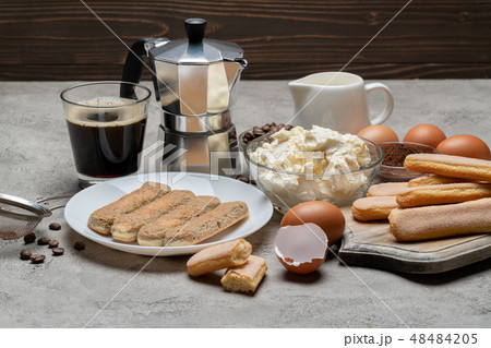 Tiramisu cake cooking - Savoiardi ladyfingers Biscuits, cheese and coffee Tiramisu cake cooking - Savoiardi ladyfingers Biscuits, cheese and coffee 48484205