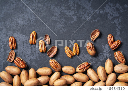 Pecan nuts on black table, with copy space. Pecan nuts on black table, with copy space. 48484510