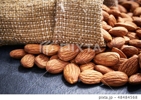 Almond in burlap sack on black table. Almond in burlap sack on black table. 48484568