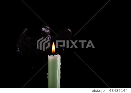 A burning pale green candle 48485144