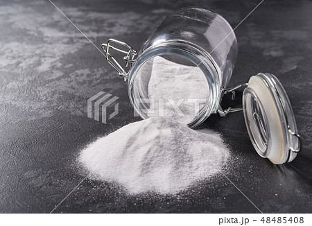 Jar of baking soda on a black background. 48485408