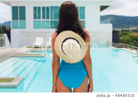 Young bright brunette woman blue swimsuit relaxing 48489310