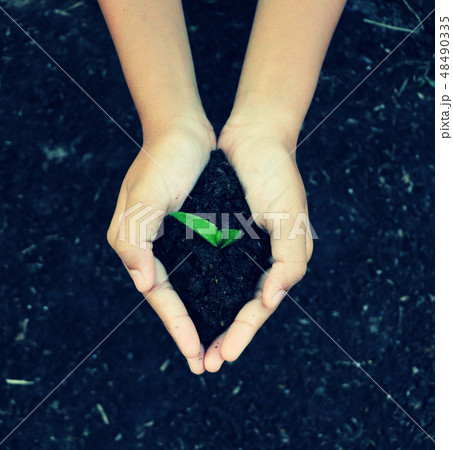 Hands holding plant and soil for growing 48490335