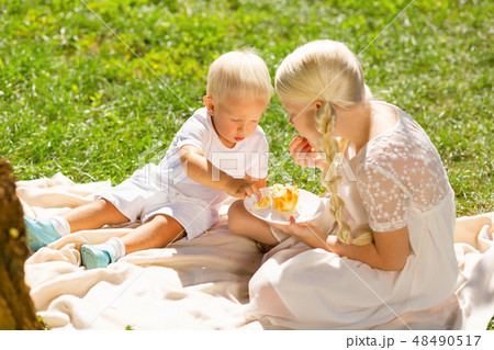 Calm children eating sweets in the park 48490517