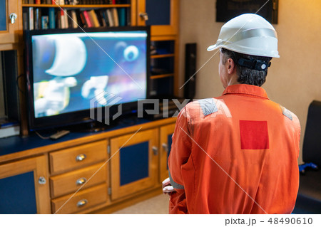 Marine chief officer having fun watching TV 48490610